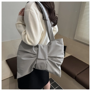 Detail of grey oversized bow shoulder bag in shiny nylon fabric for women