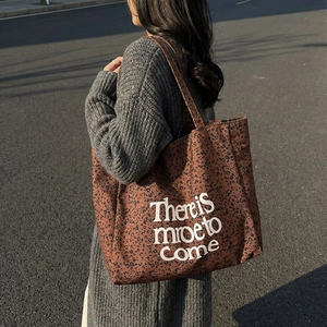Leopard print canvas tote bag with lettering on a model for daily casual style
