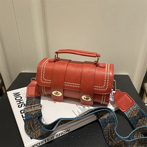 Retro red cylindrical handbag with gold studs and ethnic style embroidered strap