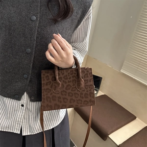 Fashionable leopard print faux suede tote bag with dual handles and crossbody strap