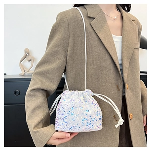 Détail du sac seau à paillettes blanches avec reflets multicolores scintillants