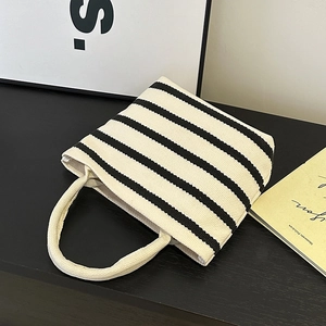 Minimalist striped canvas handbag with thick top handles and a black-and-white chic design