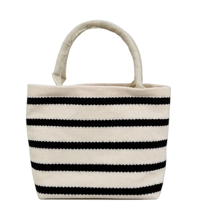 Minimalist black and white striped canvas tote bag with woven handles on white background
