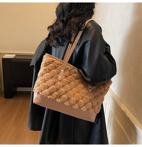 Close-up of contrast faux fur bucket bag with textured plush finish and leather straps