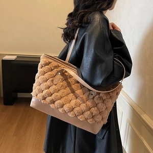 Minimalist faux fur and leather patchwork tote bag with textured plush design