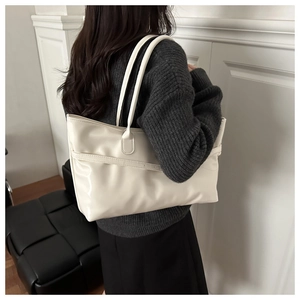 Chic cream white leather tote bag shown from a side-view on model for daily commute