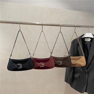 Retro motorcycle style baguette bags in black, burgundy, and brown leather with silver buckles