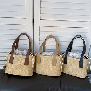 Handwoven straw tote bags with leather handles in brown, beige, and black for beach vacation
