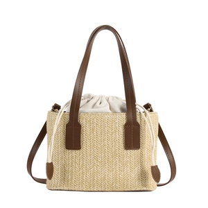 Straw shoulder bag with woven V-pattern, brown leather handles and drawstring inner bag