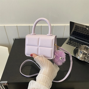 Lavender purple quilted mini handbag with plush monster charm and round handle