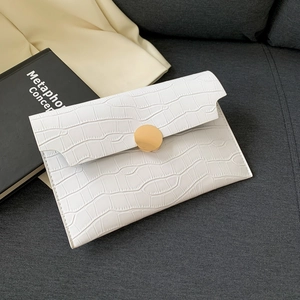 White faux crocodile skin envelope clutch bag with a large golden round metal buckle