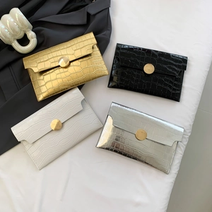 Minimalist envelope clutches in metallic stone texture with large gold round buckles