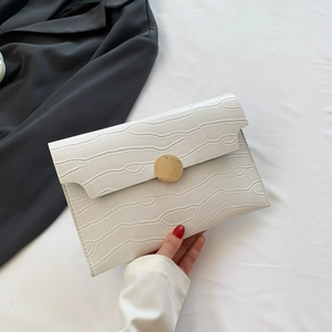 White faux crocodile skin envelope clutch bag with a round gold metal closure clasp