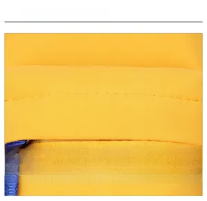 Detail shot of durable yellow nylon fabric with double stitching and blue woven strap