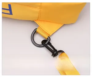 Detail of durable yellow nylon bag showing black plastic D-ring and swivel hook