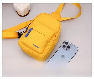 Yellow nylon kids chest bag shown next to a smartphone for size comparison
