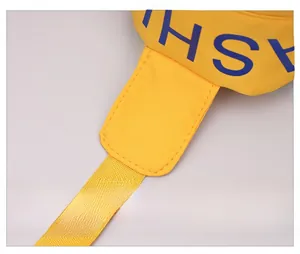Macro view of durable yellow nylon fabric with double stitching and blue text logo