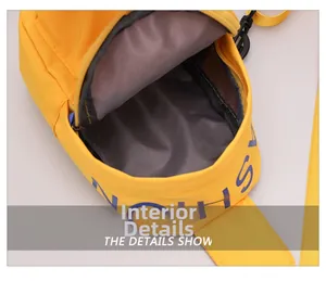 Detail view of the yellow nylon chest bag showing the smooth zipper and dark grey inner lining