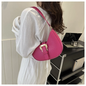 Hot pink crescent bag with croc-embossed texture and baroque gold buckle detail