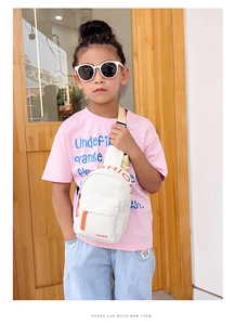 Close-up of kids crossbody bag with fashion print and orange contrast zipper pull