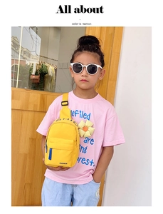 Detail of yellow nylon kids chest bag with blue zipper and black adjustable strap