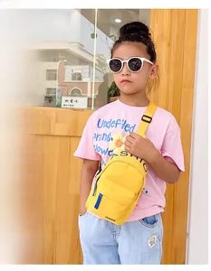 Detail of yellow nylon kids crossbody bag with sunflower decor and fashion print