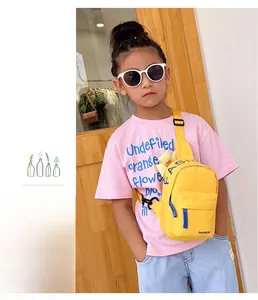 Detail of kids bright yellow nylon chest bag with blue zipper and adjustable strap