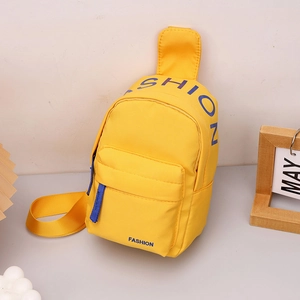 Detail of yellow nylon kids chest bag with blue Fashion logo and zipper pull