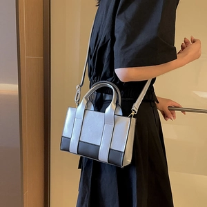 Silver and black contrast tote bag with top handles and adjustable long shoulder strap