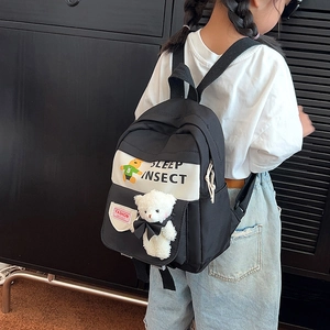 Kids black and white bear backpack with plush toy pendant and letter print for school