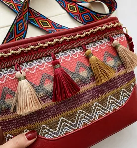 Detail of bohemian woven texture with colorful tassels and ethnic pattern strap