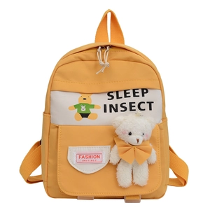 Yellow kids backpack with cartoon bear print and cute plush toy charm for school and travel