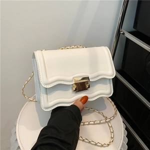 White wave-edge crossbody bag with gold chain strap and metallic rectangular clasp