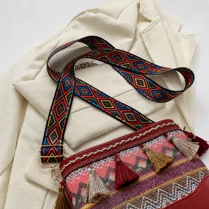 Detail of adjustable geometric jacquard strap and silk tassels on bohemian shoulder bag