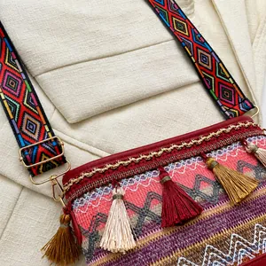 Detail of bohemian crossbody bag with colorful woven patterns and tassel decorations