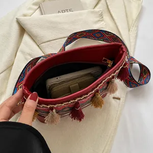 Detail showing the internal storage capacity and red bohemian tassel crossbody bag texture