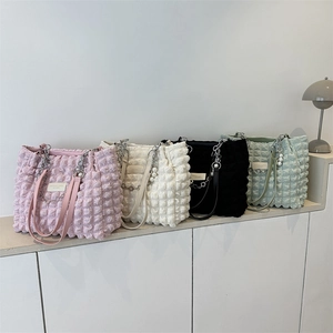 Quilted puffer tote bags in four pastel colors with metal chains and pearl charms