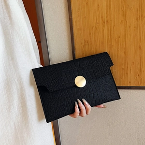Elegant black faux crocodile skin envelope clutch with a round gold buckle closure