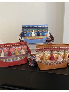 Ethnic bohemian crossbody bags with colorful weave and tassels in red, blue, and brown
