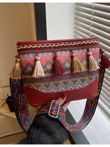 Ethnic bohemian crossbody bag with colorful tassels and patterned wide shoulder strap