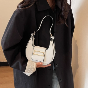 Chic white leather crescent underarm bag with gold metal buckle on black clothing