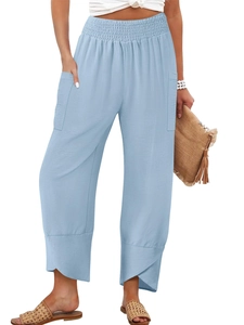 Detail of light blue wide leg cotton linen trousers with unique cross-over hem design