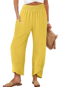 Detail of high waist elastic waistband and overlap tulip hem on yellow linen pants