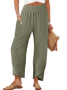 Detail of high waisted olive green cotton linen trousers with elastic waist and side pockets