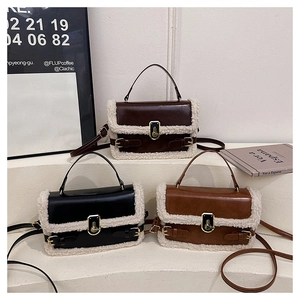 Three lamb wool trimmed leather crossbody bags shown in a tiered luxury display setting