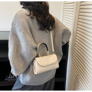 Model view of cream white vintage square handbag with sleek top handle and slim shoulder strap