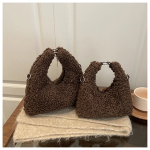 Close-up of brown plush handbags with metal ring handles in two different sizes