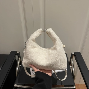 White plush crescent handbag made of soft fleece with a top handle and shoulder strap