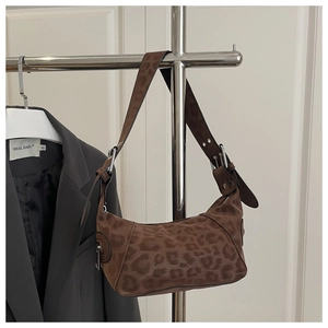 Detail of leopard print hobo bag showing faux suede texture and adjustable strap