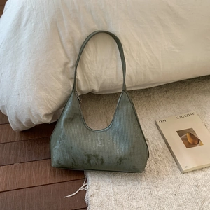 Green hobo bag with vertical textures and slim shoulder strap for daily commuting